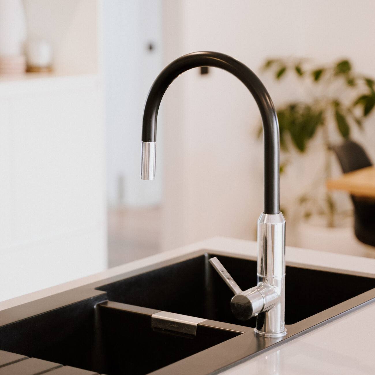 The beautiful modern style black faucet with steel sink in the kitchen